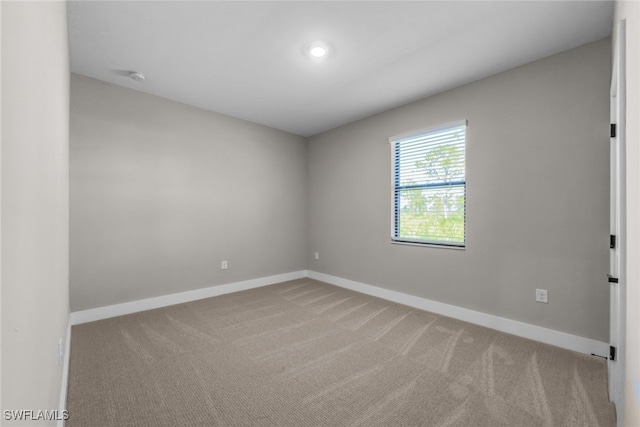 empty room with baseboards and carpet floors