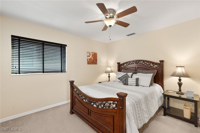 bedroom with ceiling fan and light carpet