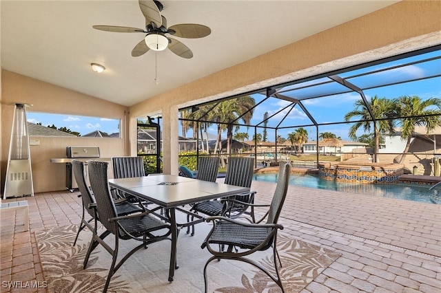 view of patio / terrace featuring pool water feature, ceiling fan, a swimming pool with hot tub, and glass enclosure