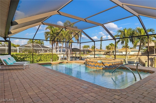 view of pool featuring a lanai, a patio, and an in ground hot tub