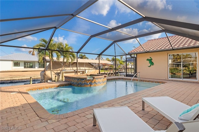 view of swimming pool with a lanai, an in ground hot tub, and a patio