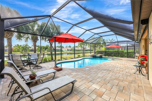 view of swimming pool featuring a lanai, a patio, a water view, and an in ground hot tub