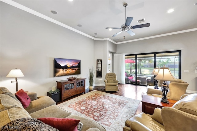 living room featuring crown molding, ceiling fan, and wood-type flooring