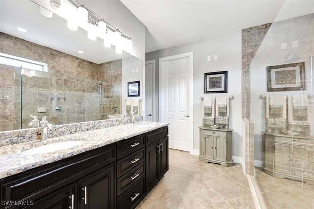 bathroom with vanity and a shower with shower door