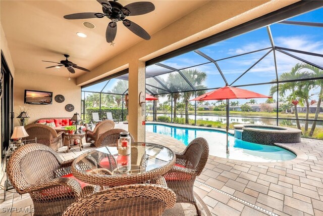 view of patio / terrace with a lanai, ceiling fan, outdoor lounge area, a water view, and a pool with hot tub