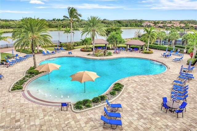 view of swimming pool featuring a gazebo, a patio area, and a water view