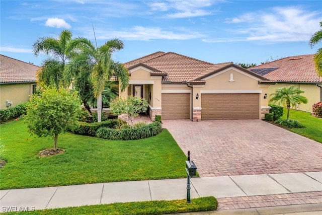 mediterranean / spanish home with a garage and a front yard