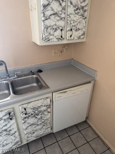 kitchen with tile patterned floors, white cabinetry, sink, and white dishwasher