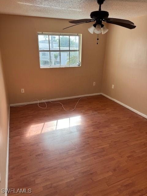 unfurnished room with wood-type flooring, a textured ceiling, and ceiling fan