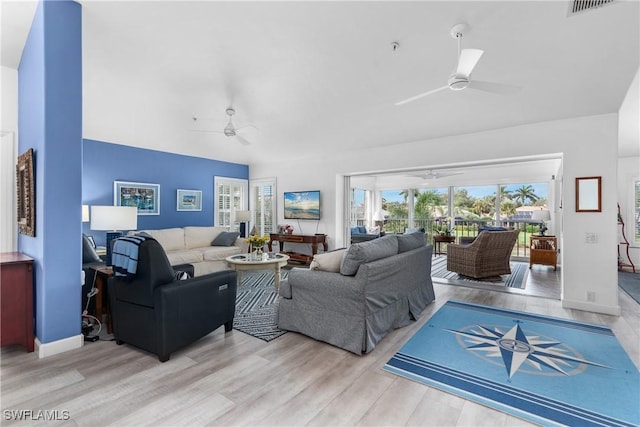 living room with ceiling fan and hardwood / wood-style flooring