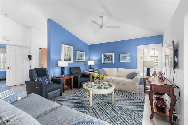 living room with light wood-type flooring, vaulted ceiling, and ceiling fan