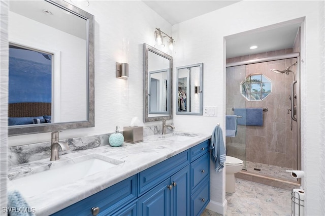 bathroom featuring vanity, toilet, and a shower with door