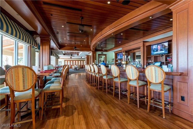 dining area featuring ceiling fan, ornamental molding, wood ceiling, and hardwood / wood-style flooring