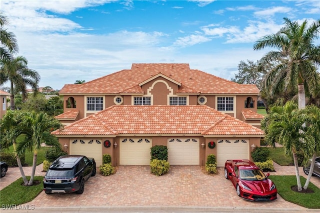 mediterranean / spanish-style house with a garage