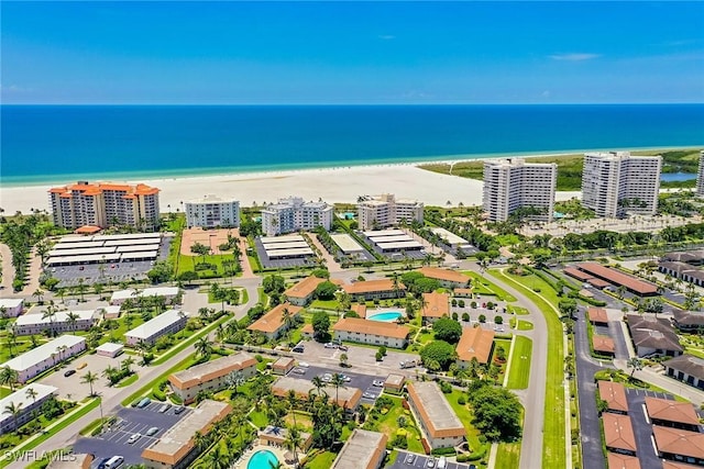 drone / aerial view featuring a water view and a beach view