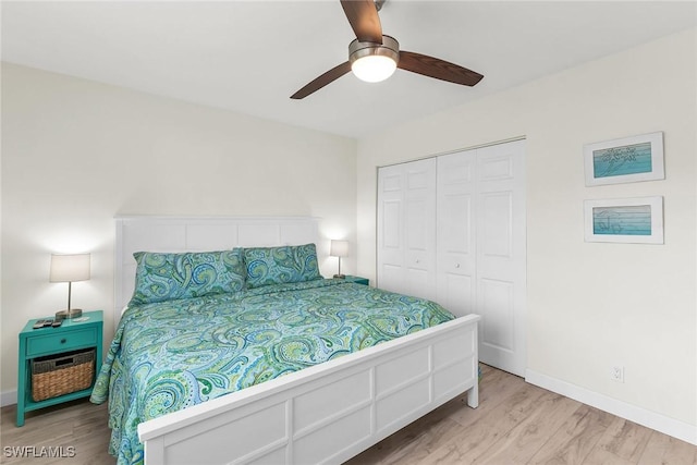 bedroom featuring light wood-type flooring, a closet, and ceiling fan