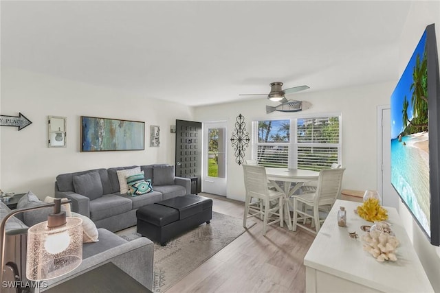 living room with light hardwood / wood-style flooring, plenty of natural light, and ceiling fan