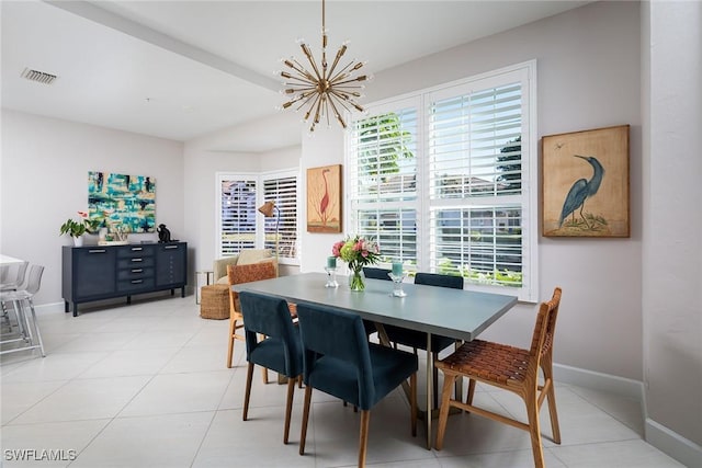 dining room featuring tile patterned flooring, plenty of natural light, and a chandelier