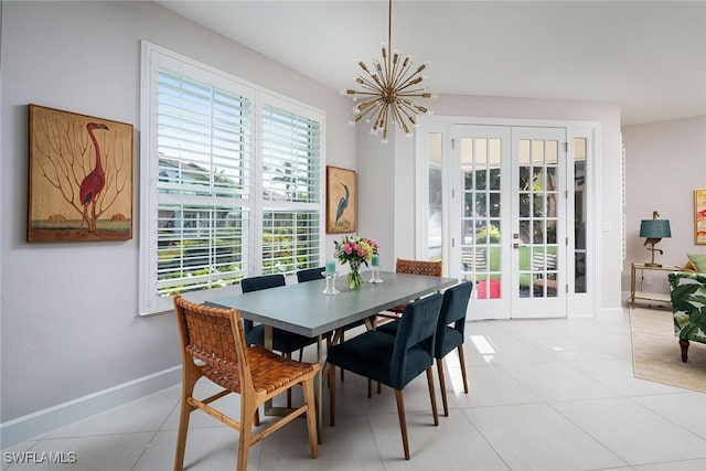 dining room featuring an inviting chandelier, light tile patterned floors, and french doors