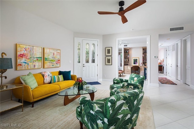 living room with ceiling fan and light tile patterned floors