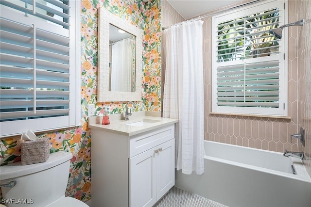 full bathroom featuring vanity, shower / tub combo with curtain, and toilet