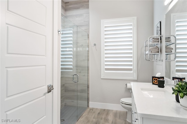 bathroom featuring walk in shower, vanity, toilet, and wood-type flooring