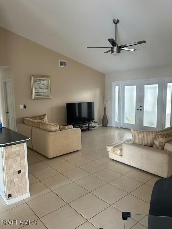 unfurnished living room featuring french doors, vaulted ceiling, ceiling fan, and light tile patterned flooring