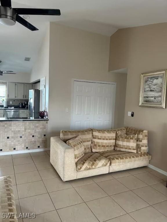 living room with high vaulted ceiling, ceiling fan, and light tile patterned flooring