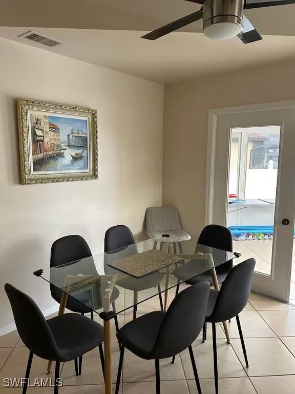 dining room featuring light tile patterned floors, plenty of natural light, and ceiling fan