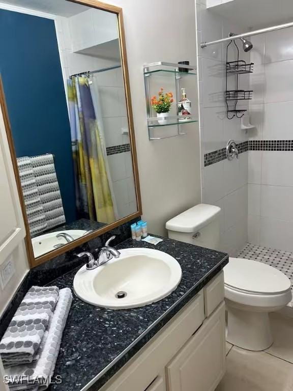 bathroom with tile patterned flooring, vanity, toilet, and a shower with curtain