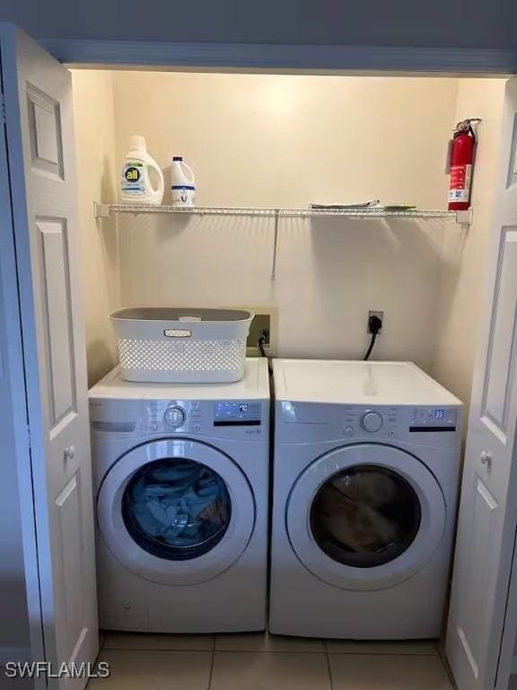 washroom featuring tile patterned floors and separate washer and dryer