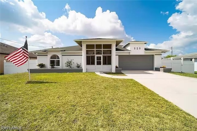 view of front of property featuring a front lawn and a garage