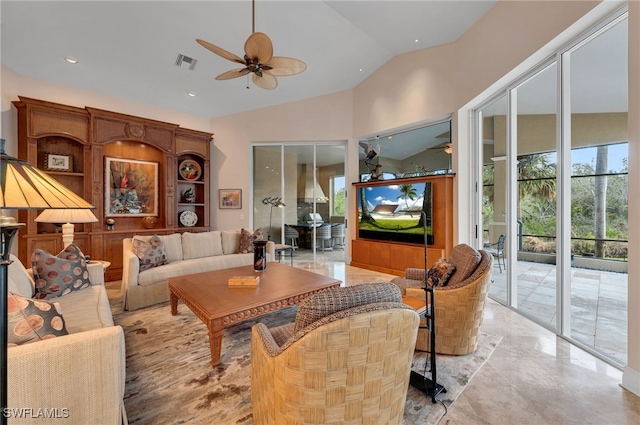 living room featuring ceiling fan and vaulted ceiling