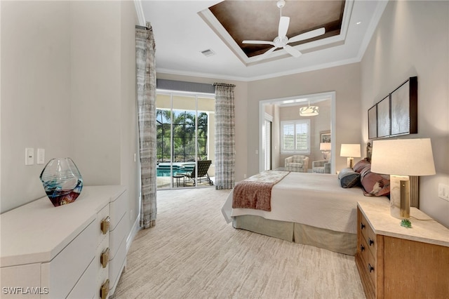 bedroom with light colored carpet, ceiling fan, a raised ceiling, and ornamental molding