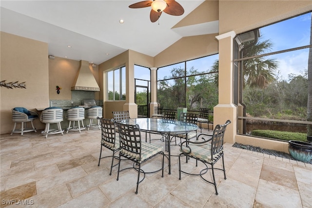 sunroom / solarium featuring ceiling fan and lofted ceiling