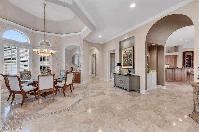 dining space with crown molding and a notable chandelier