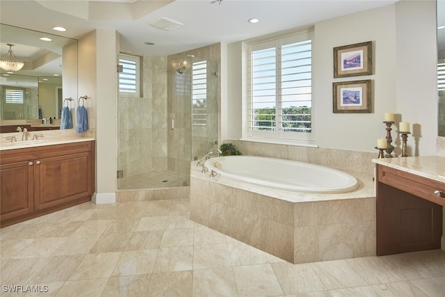 bathroom featuring vanity and shower with separate bathtub