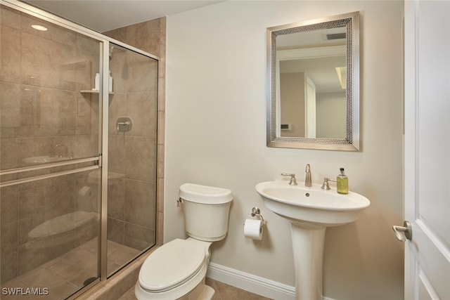 23850 Via Italia Cir Unit 406, Estero, FL 34134 - bathroom with baseboards, toilet, a stall shower, and a sink