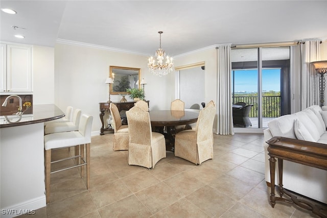 dining room featuring an inviting chandelier, sink, light tile patterned floors, and ornamental molding