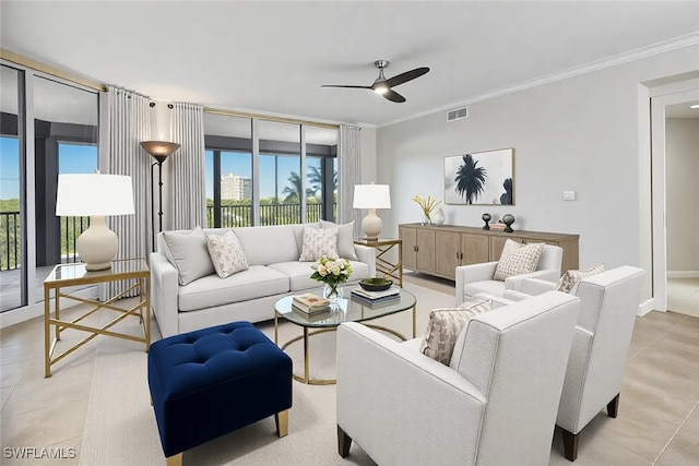 living room with light tile patterned floors, ceiling fan, visible vents, and crown molding