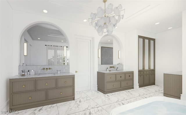 bathroom featuring vanity, tasteful backsplash, and an inviting chandelier