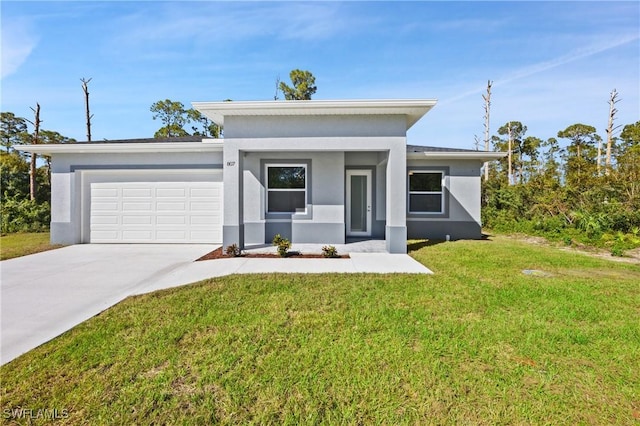 view of front of house featuring a garage and a front yard