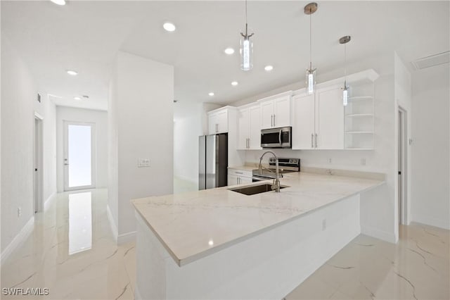 kitchen featuring kitchen peninsula, light stone countertops, appliances with stainless steel finishes, decorative light fixtures, and white cabinetry