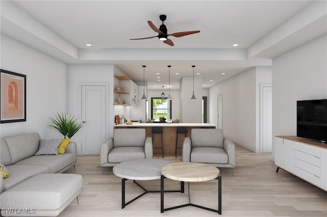 living room with ceiling fan and light hardwood / wood-style floors