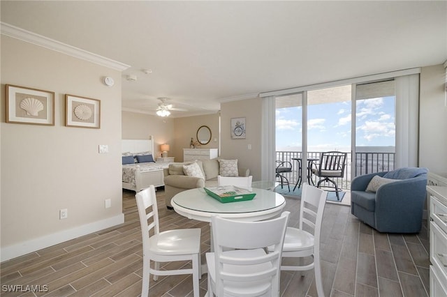 dining space featuring expansive windows, crown molding, and ceiling fan