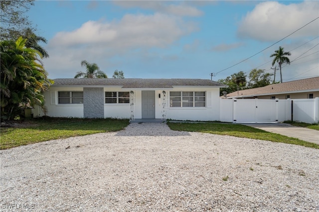 single story home featuring a front lawn