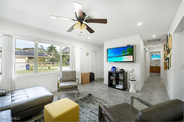 tiled living room featuring ceiling fan