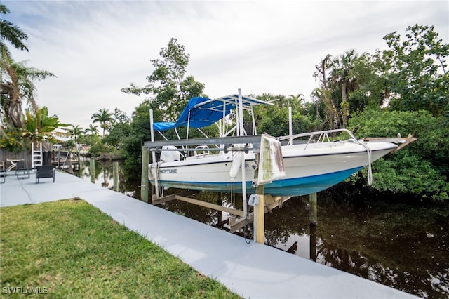 dock area with a yard and a water view