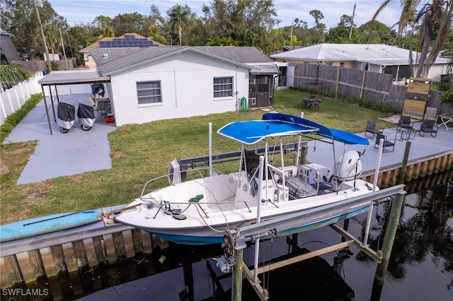 view of dock with a water view and a yard