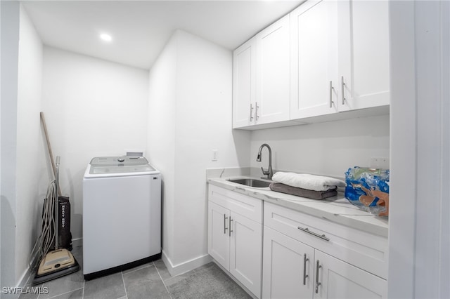 laundry area featuring cabinets, washer / dryer, light tile patterned floors, and sink